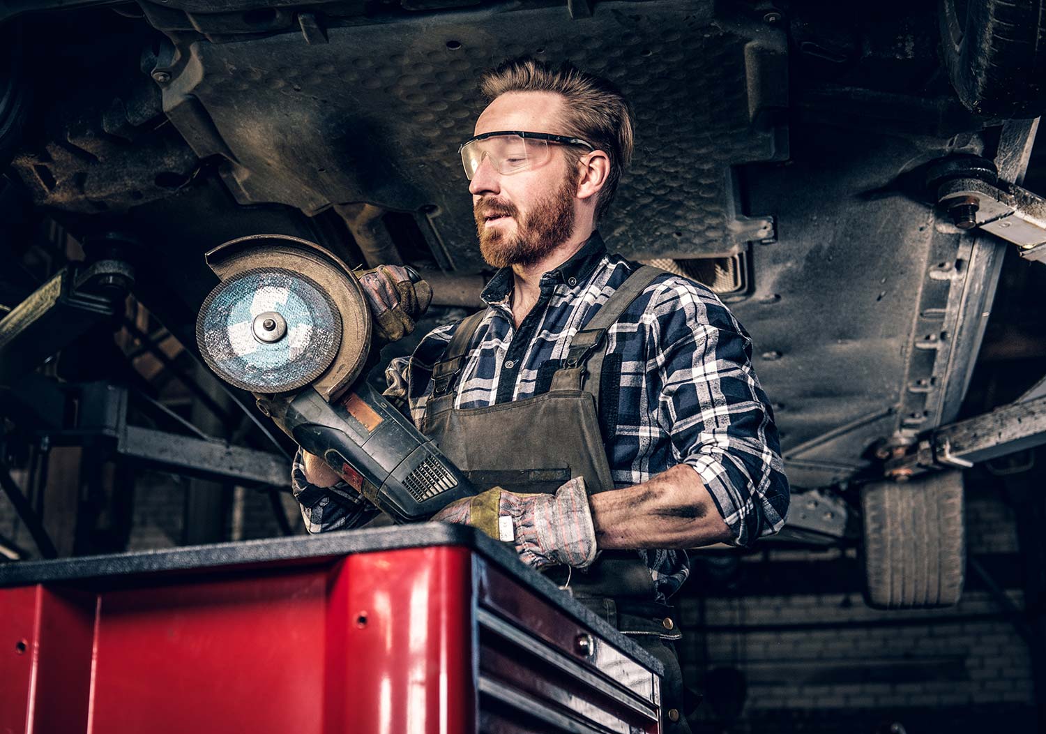 mechanic-in-protective-googles-holds-angle-grinder-small.jpg